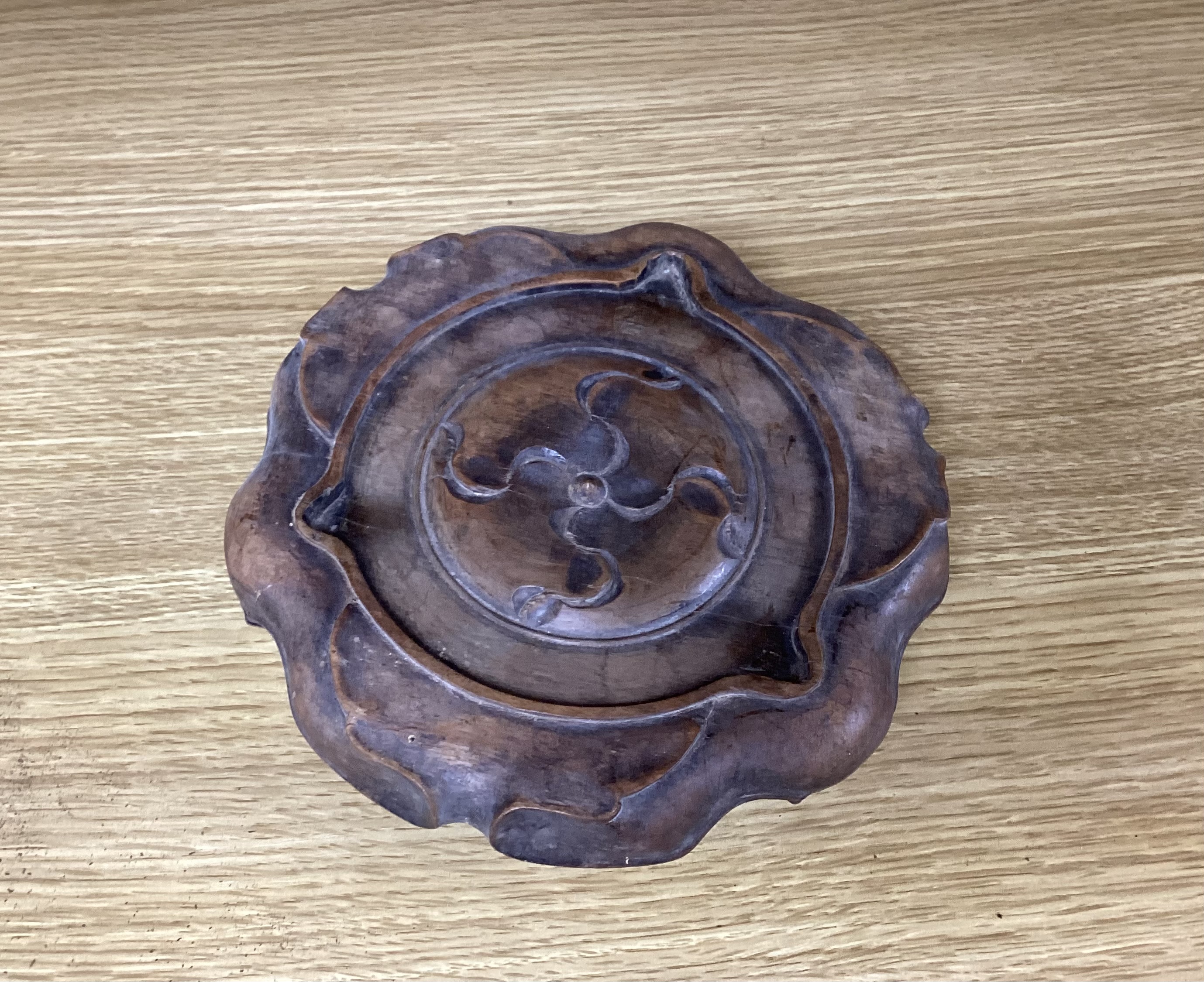 A Chinese bronze tripod censer with twin handles on hardwood stand, censer 19cm wide
